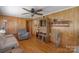 Cozy living room with wood-paneled walls, ceiling fan, and comfortable seating at 602 Dallas Spencer Mountain Rd, Dallas, NC 28034