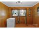 Well lit room featuring wood paneling and updated appliances at 602 Dallas Spencer Mountain Rd, Dallas, NC 28034