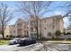 Exterior of multi-Gathering residential building surrounded by mature trees, and car parking at 6134 Meadow Rose Ln, Charlotte, NC 28215