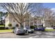 Residential multi-Gathering condo building with car parking and mature trees on a sunny day at 6134 Meadow Rose Ln, Charlotte, NC 28215