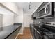 Modern kitchen featuring black cabinets, granite countertops, and stainless steel appliances at 6134 Meadow Rose Ln, Charlotte, NC 28215