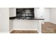 Modern kitchen featuring black cabinets, granite countertops, and stainless steel appliances at 6134 Meadow Rose Ln, Charlotte, NC 28215