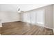 Bright living room featuring wood floors, neutral walls, and glass doors leading to outdoor space at 6134 Meadow Rose Ln, Charlotte, NC 28215
