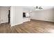 Bright open living room with hardwood-style floors, ceiling fan, and modern kitchen view at 6134 Meadow Rose Ln, Charlotte, NC 28215