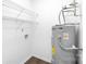 Utility room featuring a modern water heater and functional shelving at 6134 Meadow Rose Ln, Charlotte, NC 28215