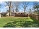 Lush backyard featuring a wooden deck, green lawn, and privacy fence, perfect for outdoor activities at 6136 Montpelier Rd, Charlotte, NC 28210