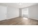 Neutral bedroom with natural light and plank flooring at 6142 Meadow Rose Ln, Charlotte, NC 28215