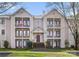Multi-level condo with balconies, well-maintained landscaping, and brick stairway at 6142 Meadow Rose Ln, Charlotte, NC 28215