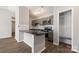 Eat-in kitchen featuring modern appliances, gray cabinetry, and breakfast bar at 6142 Meadow Rose Ln, Charlotte, NC 28215