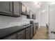 Modern kitchen with stainless steel appliances, gray cabinets, and subway tile backsplash at 6142 Meadow Rose Ln, Charlotte, NC 28215
