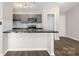 Open kitchen with gray cabinets, sleek countertops, and modern lighting at 6142 Meadow Rose Ln, Charlotte, NC 28215