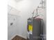 Functional laundry room area with shelving and modern water heater at 6142 Meadow Rose Ln, Charlotte, NC 28215