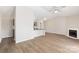 Open-concept living area with modern kitchen, fireplace, and wood flooring at 6142 Meadow Rose Ln, Charlotte, NC 28215