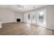 Bright living room with fireplace, wood floors, and access to outdoor space at 6142 Meadow Rose Ln, Charlotte, NC 28215