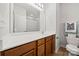 Well-lit bathroom with white countertops and wood cabinets and large mirror above the sink at 6936 Colonial Garden Dr, Huntersville, NC 28078