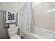 Clean bathroom with shower and white lace curtains on the shower/tub combination at 6936 Colonial Garden Dr, Huntersville, NC 28078
