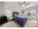 Cozy bedroom featuring a plush bed, a ceiling fan, and natural light from two windows at 6936 Colonial Garden Dr, Huntersville, NC 28078