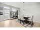 Bright dining area with natural light, a modern table, and a decorative plant stand near the back door at 6936 Colonial Garden Dr, Huntersville, NC 28078