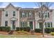 Charming townhome featuring traditional architecture, manicured landscaping, and a welcoming front entrance at 6936 Colonial Garden Dr, Huntersville, NC 28078