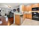 Open concept kitchen with stainless dishwasher, granite countertops, and access to the cozy living room at 6936 Colonial Garden Dr, Huntersville, NC 28078