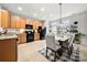 Bright kitchen and dining area boasts stainless steel appliances and a dining area filled with plants at 6936 Colonial Garden Dr, Huntersville, NC 28078