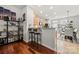 Open kitchen with bar seating and modern appliances, seamlessly connected to dining area at 6936 Colonial Garden Dr, Huntersville, NC 28078