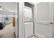 Convenient laundry area with stacked washer and dryer unit and access to the main bedroom at 6936 Colonial Garden Dr, Huntersville, NC 28078