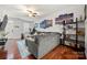 Open concept living room with modern decor and beautiful hardwood floors, perfect for relaxation at 6936 Colonial Garden Dr, Huntersville, NC 28078