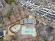Aerial view of community pool and playground surrounded by trees and neighborhood houses at 6936 Colonial Garden Dr, Huntersville, NC 28078