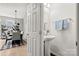 A glimpse through an open door reveals a dining area and a minimalist powder room with pedestal sink at 6936 Colonial Garden Dr, Huntersville, NC 28078