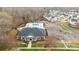 Birds-eye view of community pool and recreation building with ample parking, landscaping, and green space at 7217 Somerford Rd, Charlotte, NC 28215