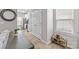 Hallway with window leads to the kitchen, and shoe rack, showcases the modern and functional design at 7217 Somerford Rd, Charlotte, NC 28215