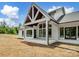 Covered back porch featuring an exposed truss, multiple windows, and a concrete foundation at 733 Barbary Pl, Lincolnton, NC 28092