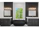 Luxurious bathroom featuring dual vanities, a freestanding tub, and a large window at 733 Barbary Pl, Lincolnton, NC 28092