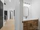 Contemporary bathroom with wood vanity, black mirror and fixtures, quartz countertop and hardwood floors at 733 Barbary Pl, Lincolnton, NC 28092