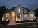An elegant brick house with exterior lighting, landscaping, and steps leading to the entrance at 733 Barbary Pl, Lincolnton, NC 28092