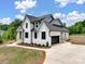 Aerial view of a well landscaped home with a large driveway and a two-car garage at 733 Barbary Pl, Lincolnton, NC 28092