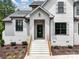 Close up of the home's front entrance featuring a painted brick facade, and wood accents on the stairway at 733 Barbary Pl, Lincolnton, NC 28092