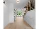 Bright hallway with natural light, modern staircase, and beautiful hardwood floors at 733 Barbary Pl, Lincolnton, NC 28092