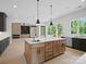 Open floor plan kitchen featuring an island with bar seating and stainless steel appliances at 733 Barbary Pl, Lincolnton, NC 28092
