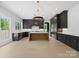 Bright, open kitchen boasts dark cabinetry, a light countertop island, and high-end stainless steel appliances at 733 Barbary Pl, Lincolnton, NC 28092