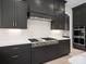 A gourmet kitchen featuring custom dark cabinets, stainless steel appliances, and a designer tile backsplash at 733 Barbary Pl, Lincolnton, NC 28092