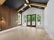 Bright living room with wood accent wall, beamed ceilings and large windows at 733 Barbary Pl, Lincolnton, NC 28092