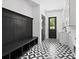 A stylish mudroom with a black and white tile floor and a built-in bench with storage at 733 Barbary Pl, Lincolnton, NC 28092