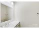 Clean bathroom features neutral color palette, ample lighting, vanity, and a modern mirror at 7364 Laurel Valley Rd, Charlotte, NC 28273
