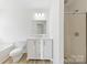 Bathroom featuring a shower, toilet, and vanity with storage at 7364 Laurel Valley Rd, Charlotte, NC 28273