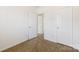 Cozy bedroom with neutral carpet, open doorway, and white trim on doors and baseboards at 7364 Laurel Valley Rd, Charlotte, NC 28273