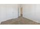Bedroom with neutral carpet, white trim, two doors, and view of another room at 7364 Laurel Valley Rd, Charlotte, NC 28273