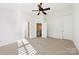 Bedroom with a ceiling fan, carpet, and doors leading to other rooms at 7364 Laurel Valley Rd, Charlotte, NC 28273