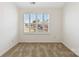 Well-lit bedroom features neutral carpet, white trim, plantation shutters, and neighborhood view at 7364 Laurel Valley Rd, Charlotte, NC 28273